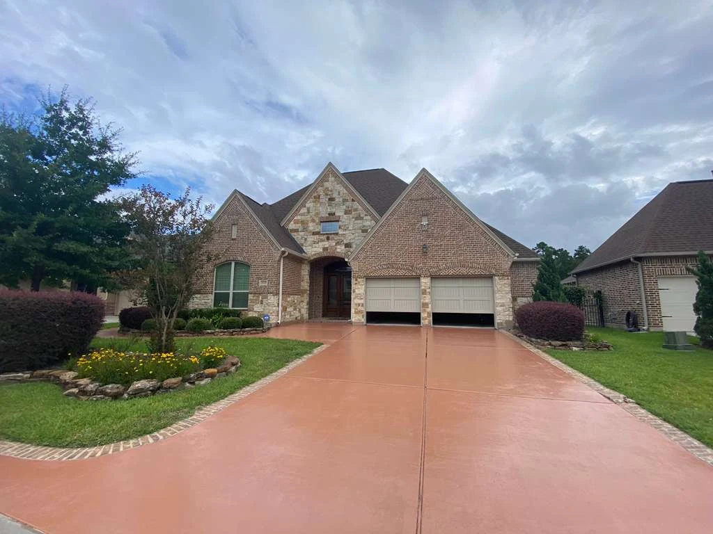 Stained concrete driveway in front of a home