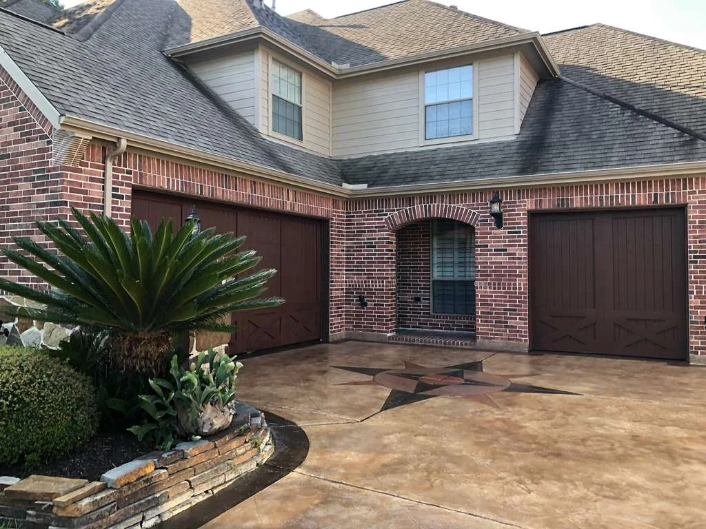 Concrete driveway at a brick home entrance