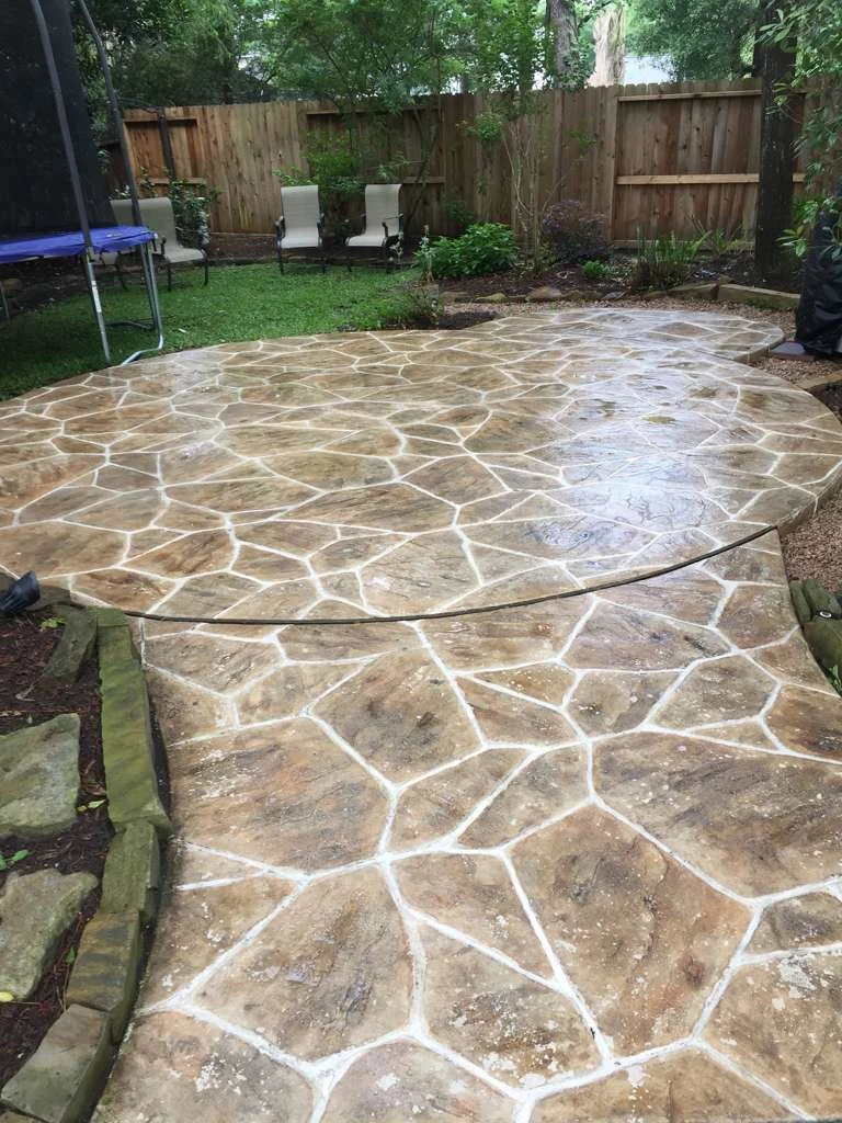 Stamped concrete surrounding a backyard pool