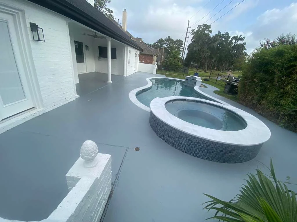 Gray concrete pool deck and covered patio